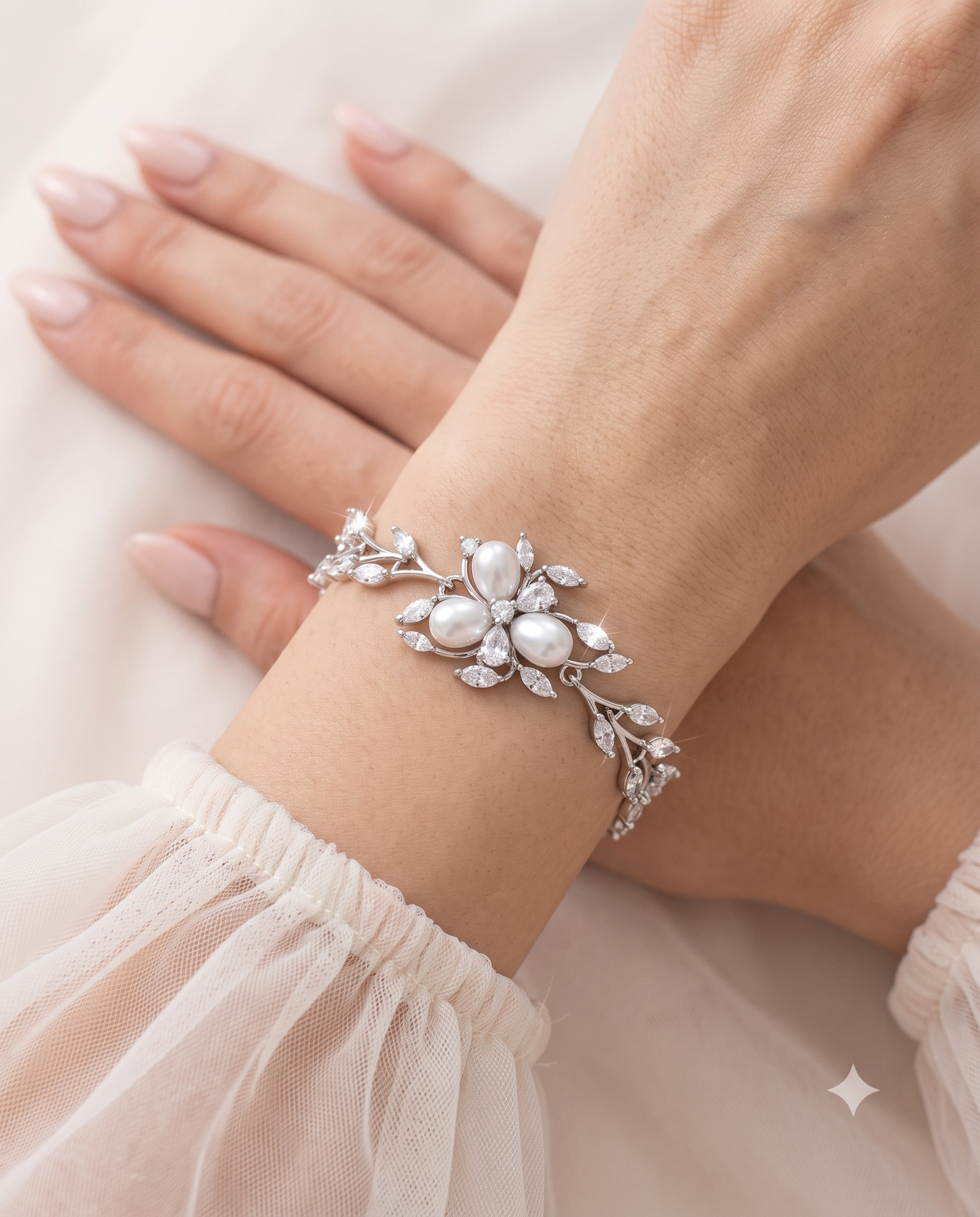 A close-up image of a person's hand wearing a bracelet with a floral design and a large crystal accent.