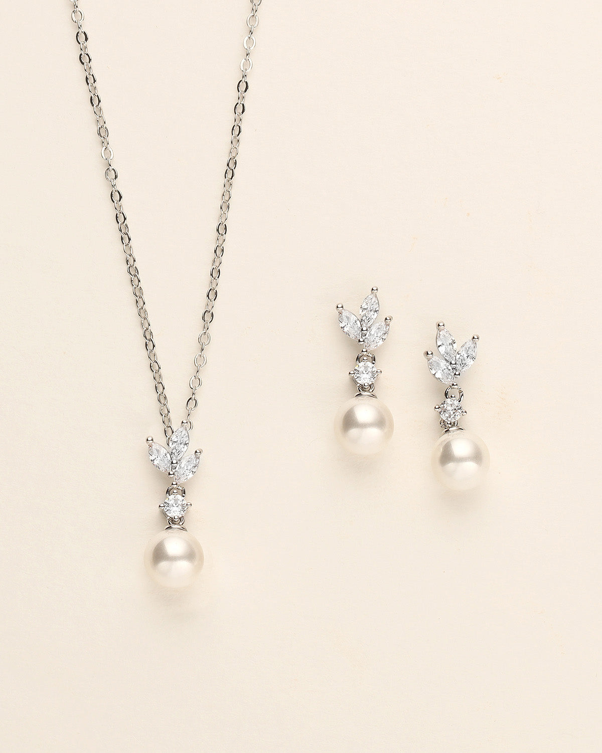 a necklace and earring set with pearls