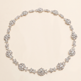 A necklace with numerous small, sparkling crystal pendants arranged in a circular pattern.