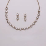A necklace and earrings set made of sparkling rhinestones and pearls.