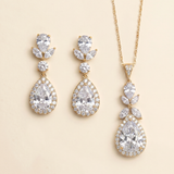 A set of elegant gold jewelry pieces, including earrings and a necklace, adorned with large, sparkling diamonds.