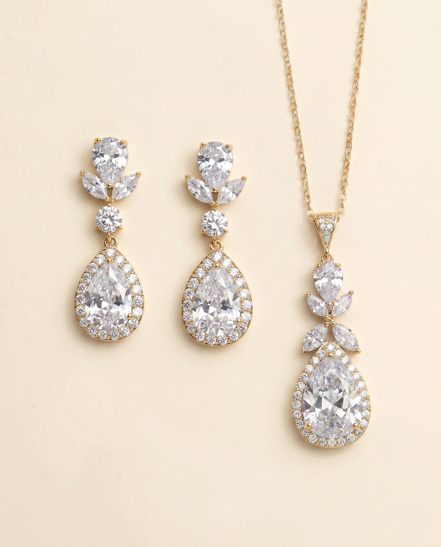 A set of elegant gold jewelry pieces, including earrings and a necklace, adorned with large, sparkling diamonds.