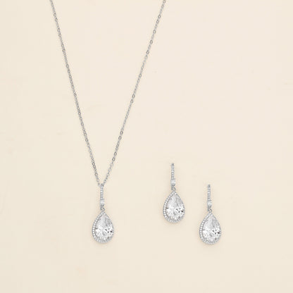 a necklace, earrings and ring set on a white background