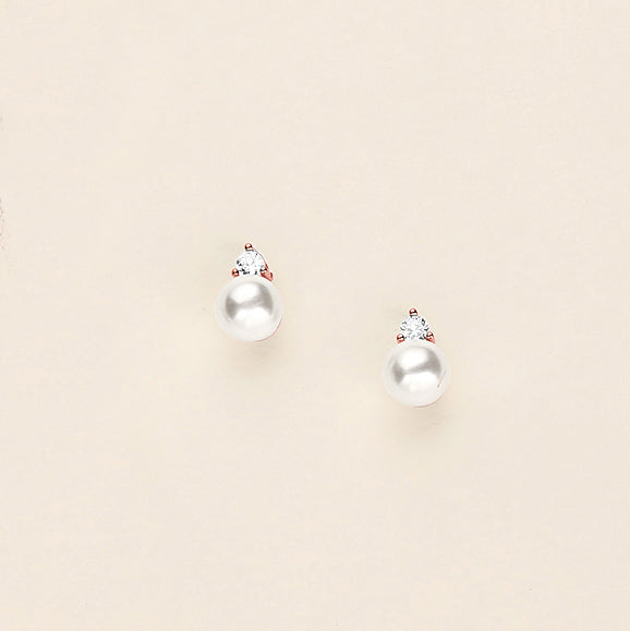 a pair of pearl earrings on a white background