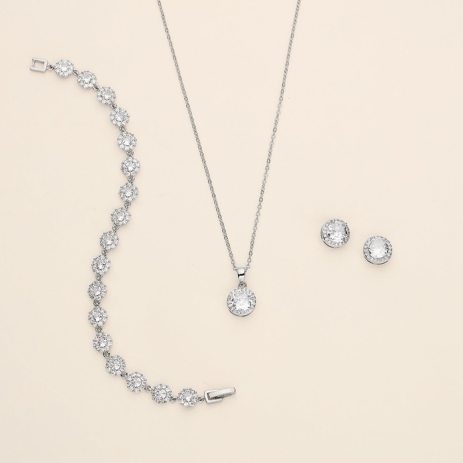 a necklace, earrings, and bracelet on a white background
