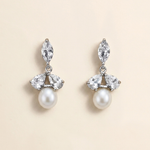 A pair of elegant earrings with a combination of pearls and diamonds.