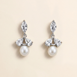 A pair of elegant earrings with a combination of pearls and diamonds.