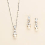 a necklace and earring set with pearls