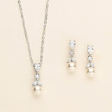 a necklace and earring set with pearls