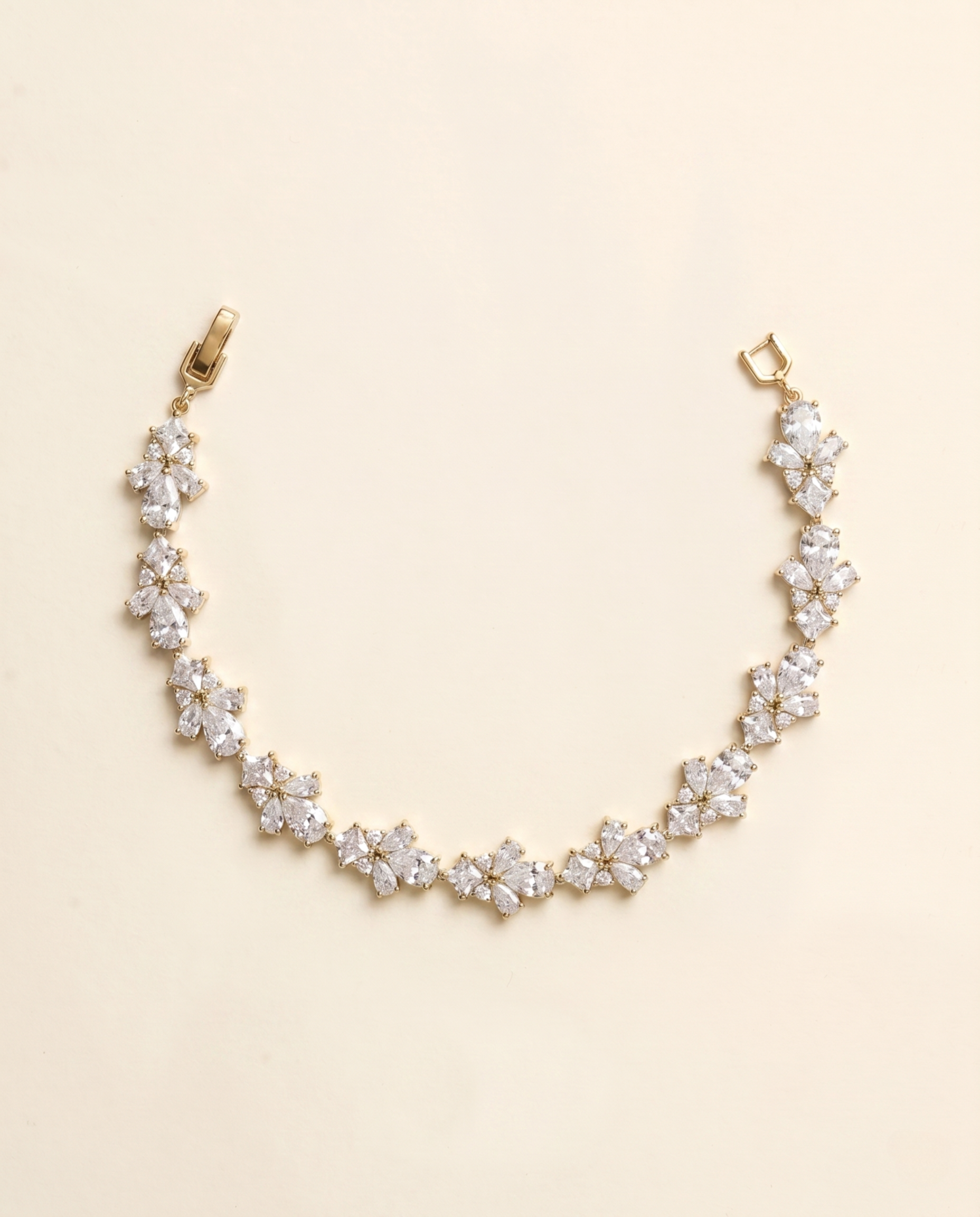 A delicate gold necklace with a row of small, clear gemstone pendants.