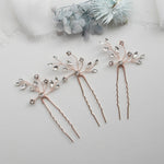 three different types of hair pins on a white surface