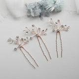 three different types of hair pins on a white surface