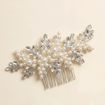 A decorative hair accessory with a comb and numerous small pearls and crystals.