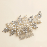 A decorative hair accessory with a comb and numerous small pearls and crystals.