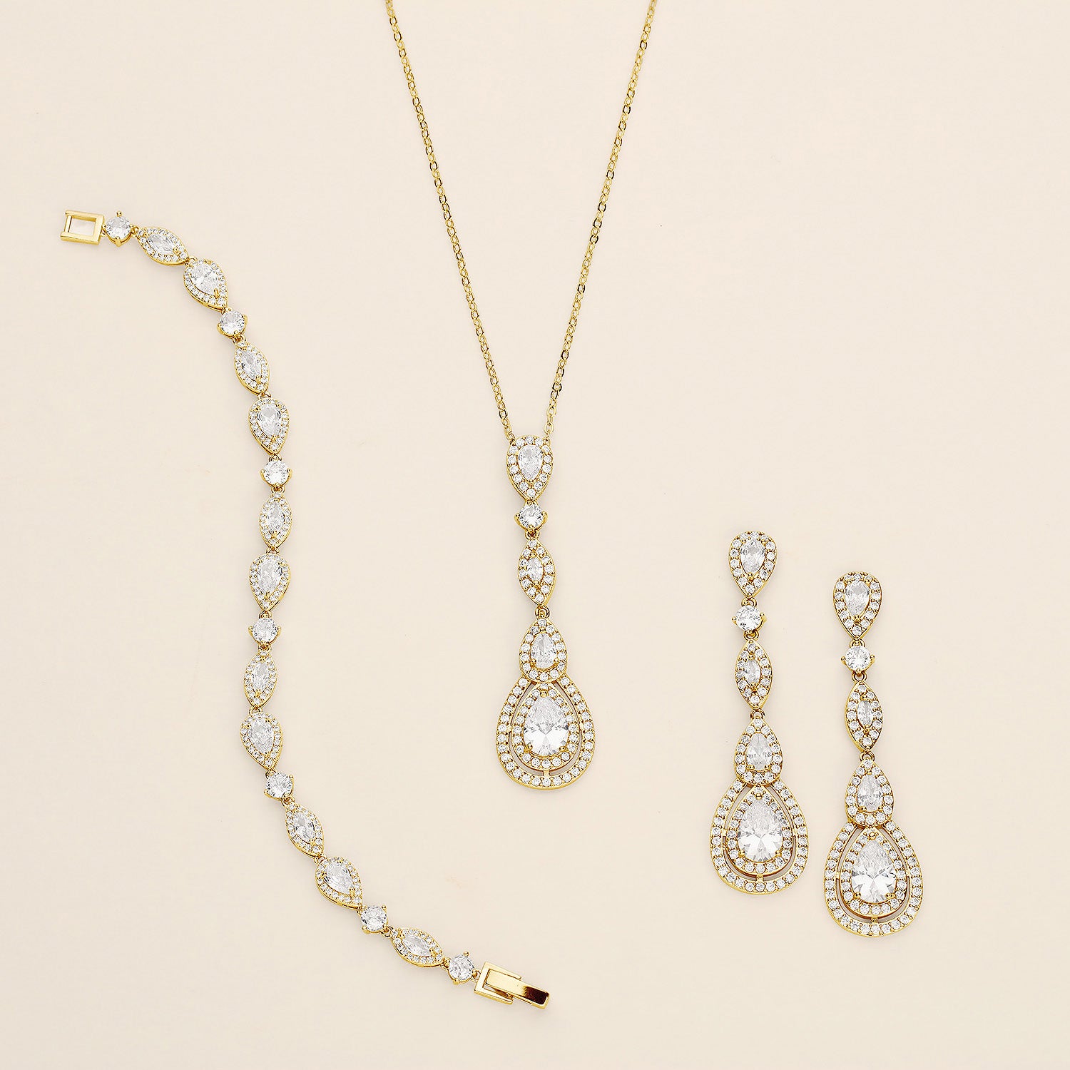 a necklace, bracelet, and earrings on a white surface