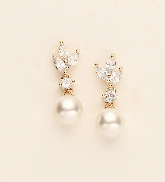 a pair of pearl and diamond earrings