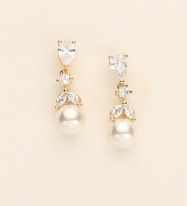 a pair of pearl and crystal earrings