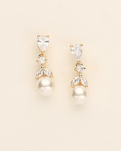 a pair of pearl and crystal earrings