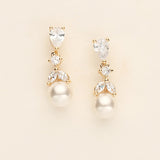 a pair of pearl and crystal earrings