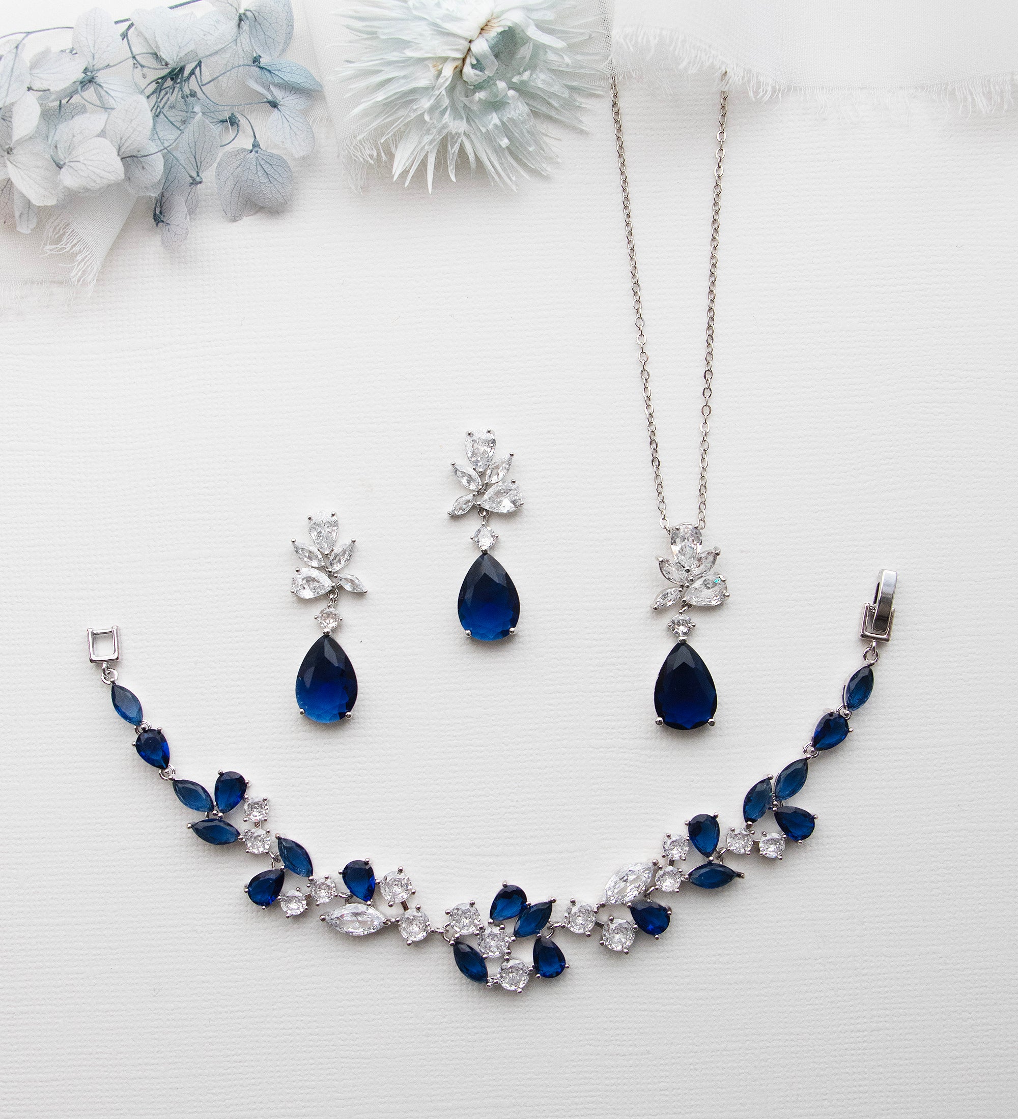 a necklace and earring set with blue stones