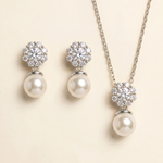 A necklace and earrings set with a combination of pearls and diamonds.