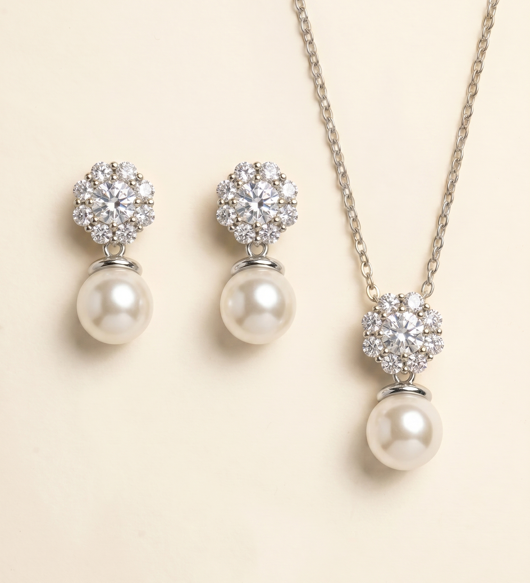 A necklace and earrings set with a combination of pearls and diamonds.