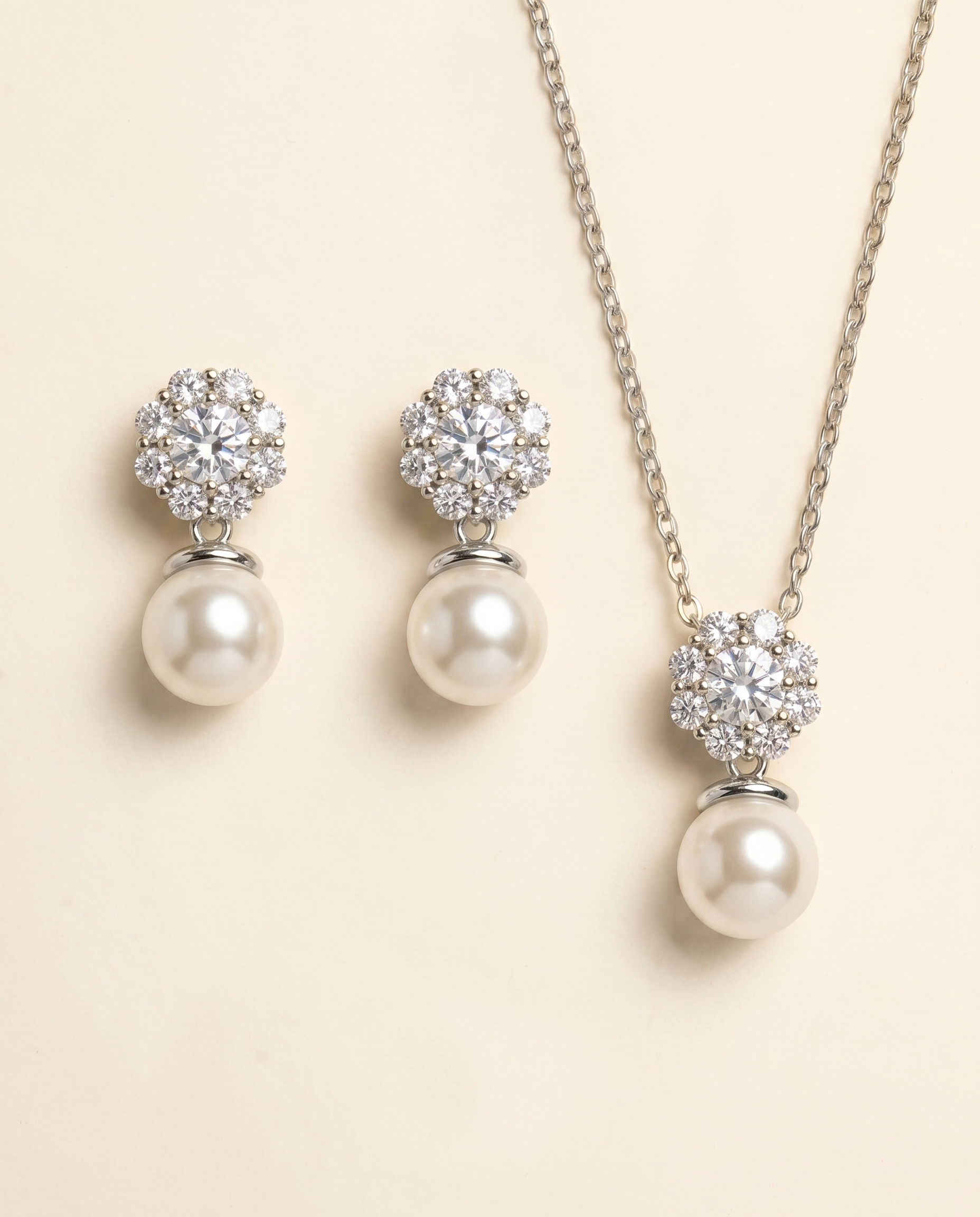 A necklace and earrings set with a combination of pearls and diamonds.