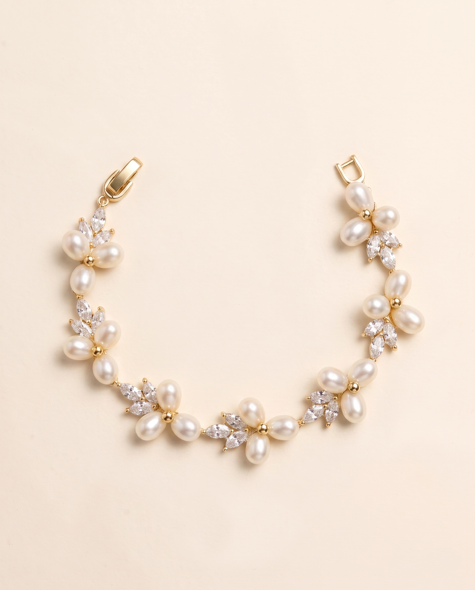 A delicate gold bracelet adorned with numerous small pearls and crystal accents.