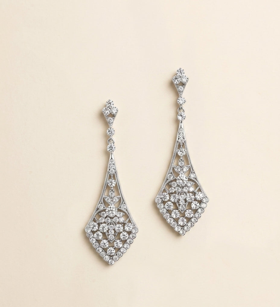 A pair of elegant diamond earrings with intricate designs and sparkling crystal elements.
