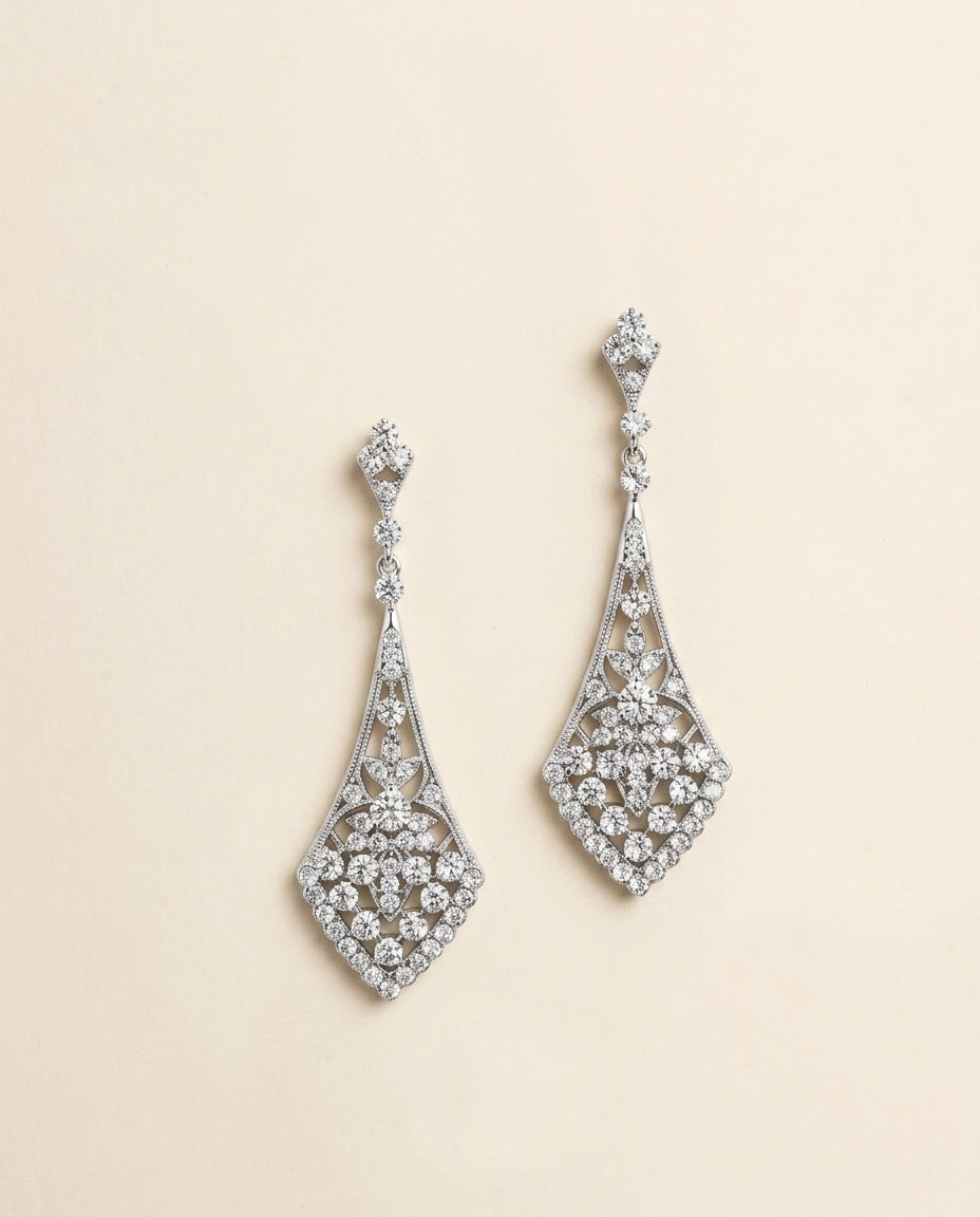 A pair of elegant diamond earrings with intricate designs and sparkling crystal elements.