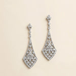 A pair of elegant diamond earrings with intricate designs and sparkling crystal elements.