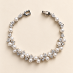 Athena silver-finish bracelet arranged in a curve, showing clustered pearl-like accents, clear faceted details and clasp