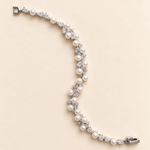 Athena silver-finish bracelet with round pearl-like accents and clear faceted details, shown full length on a cream background
