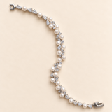 Athena silver-finish bracelet with round pearl-like accents and clear faceted details, shown full length on a cream background