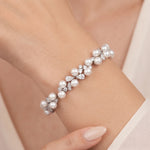 Athena silver-finish bracelet worn on a wrist, showing round pearl-like accents and clear faceted details