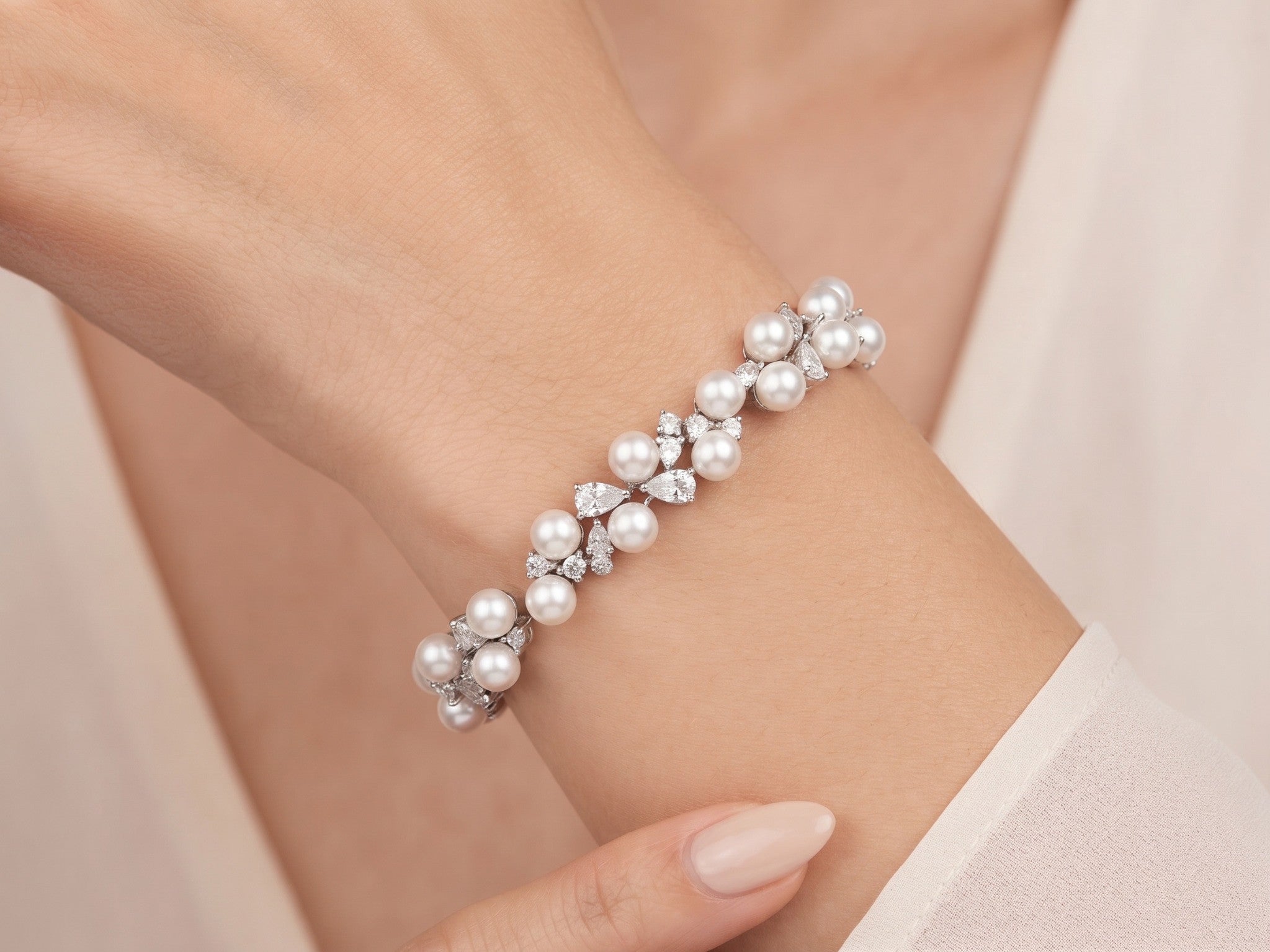 Athena silver-finish bracelet worn on a wrist, showing round pearl-like accents and clear faceted details