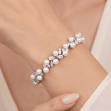 Athena silver-finish bracelet worn on a wrist, showing round pearl-like accents and clear faceted details