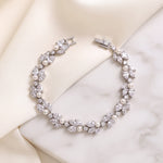 Audrey silver pearl and cubic zirconia bracelet arranged on satin and a marble surface