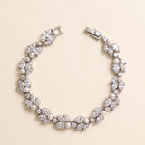 Audrey pearl and cubic zirconia bracelet in silver with leaf-inspired clusters on a cream background