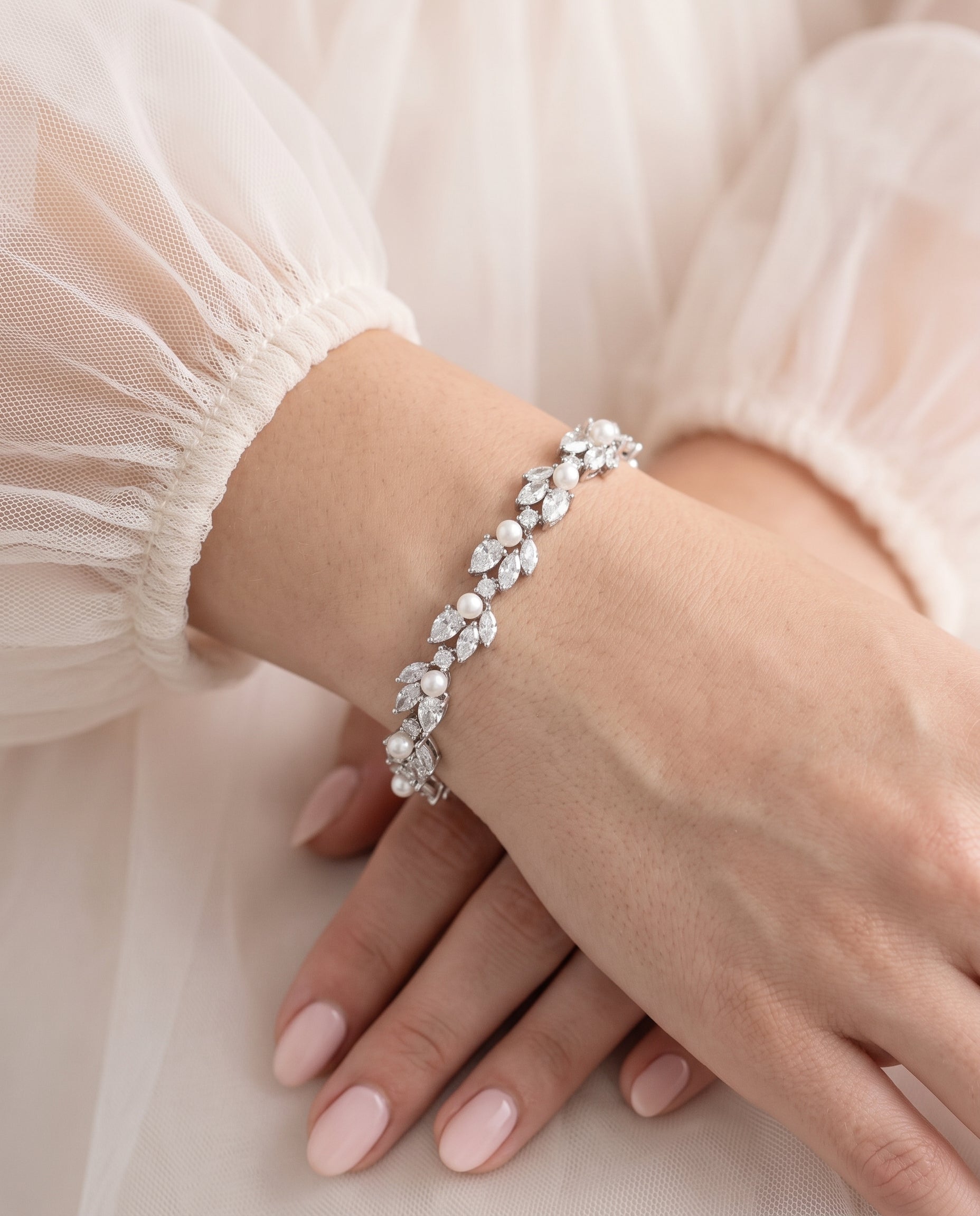 A close-up image of a person's hand wearing a bracelet with a floral design.