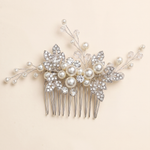 A decorative hair accessory with a floral design and sparkling crystal elements.