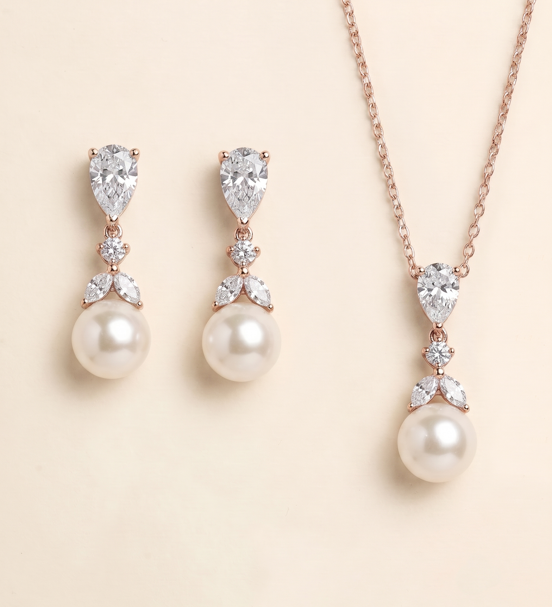 A necklace and earrings set featuring a pendant and a pearl.