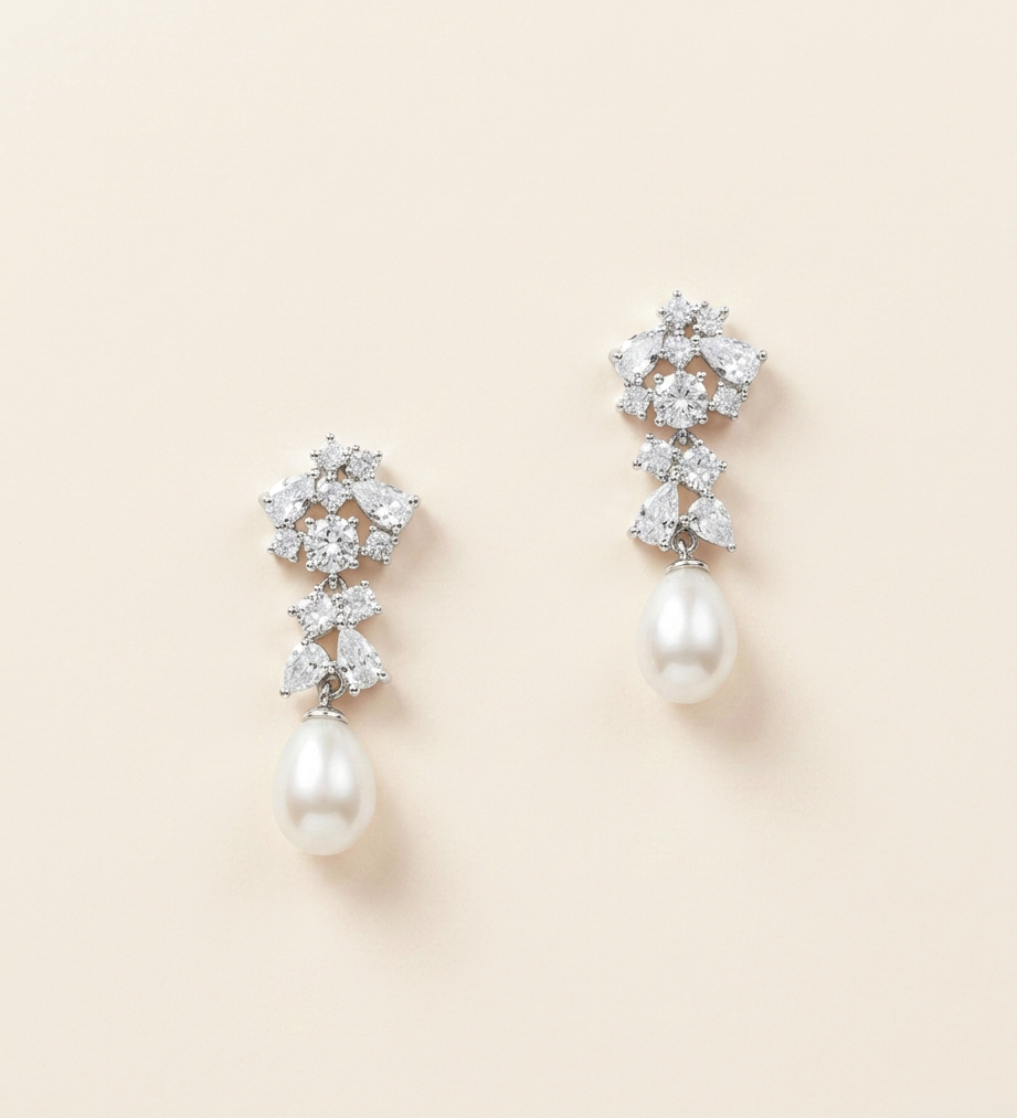 A pair of elegant earrings with a combination of pearls and diamonds.