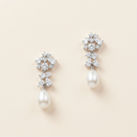 A pair of elegant earrings with a combination of pearls and diamonds.