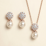 A necklace and earrings set with a delicate floral design and sparkling gemstones.