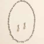 A necklace and earrings set made of silver and white pearls and diamonds.