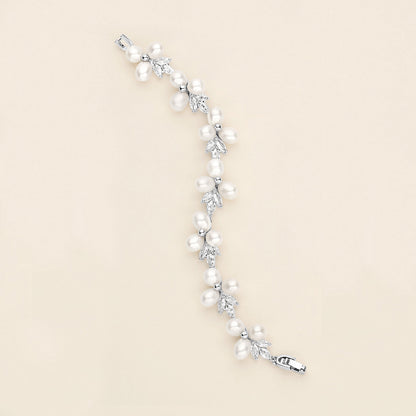 a white pearl and crystal bracelet on a white background