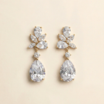A pair of elegant diamond earrings with large, clear gemstones set in a gold-colored metal.
