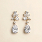 A pair of elegant diamond earrings with large, clear gemstones set in a gold-colored metal.