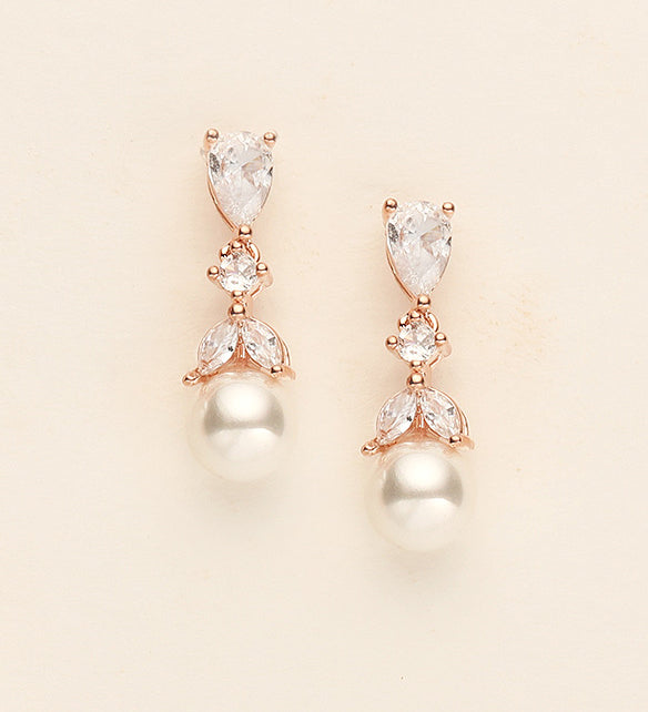 a pair of diamond and pearl earrings